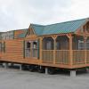 Log Cabin RV Park Model with Screened Porch on Display at Recreational Resort Cottages and Cabins in Rockwall, Texas